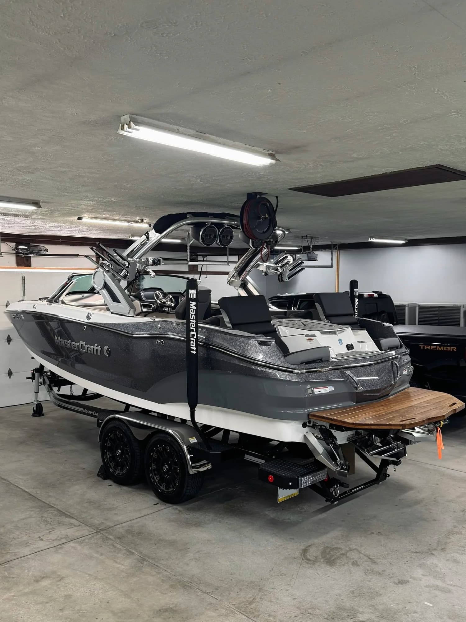 A MasterCraft wake boat on its trailer, detailed